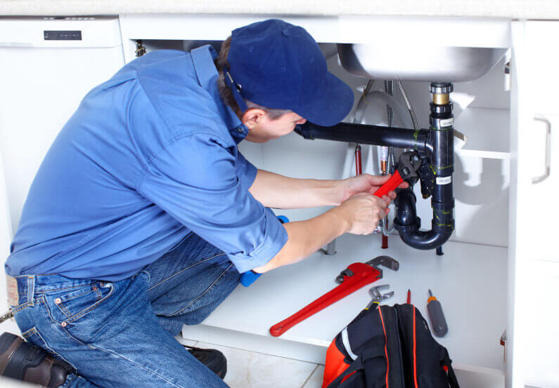 Plumber Fixing Drain Pipe